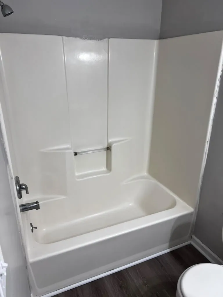 Bathtub and shower walls restored to bright white after cleaning